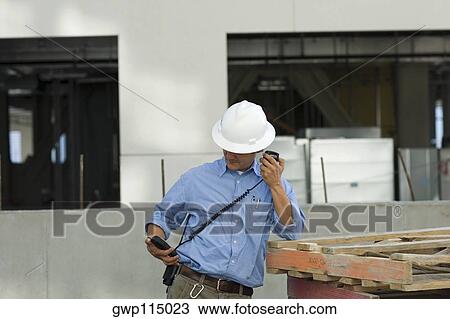 Male construction worker talking on a CB radio View Large Photo Image Stock Image - Male construction worker talking on a CB radio. Fotosearch