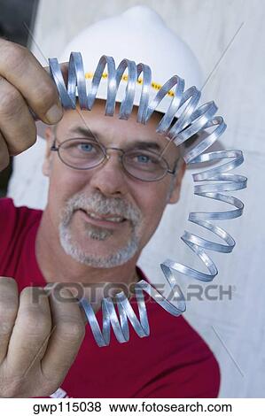 Portrait of a male construction worker folding a metal spring and smiling View Large Photo Image Stock Photo - Portrait of a male construction worker folding a metal spring and smiling. Fotosearch