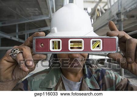 Close-up of a male construction worker holding a level View Large Photo Image Stock Image - Close-up of a male construction worker holding a level. Fotosearch