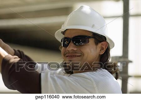 Close-up of a male construction worker smiling View Large Photo Image Stock Image - Close-up of a male construction worker smiling. Fotosearch
