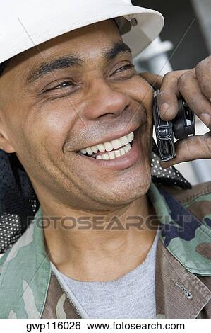Close-up of a mature man talking on a mobile phone and smiling View Large Photo Image Stock Photograph - Close-up of a mature man talking on a mobile phone and smiling. Fotosearch