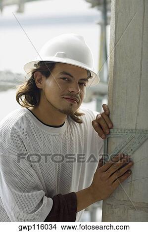 Portrait of a male construction worker using a set square View Large Photo Image Picture - Portrait of a male construction worker using a set square. Fotosearch