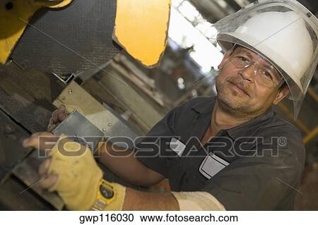 Stock Image - Portrait of a male construction worker working. Fotosearch
