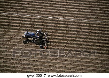 Stock Photo - Aerial, plowing farm field. Fotosearch