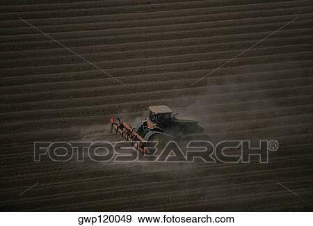 Stock Photo - Plowing farm field, aerial. Fotosearch