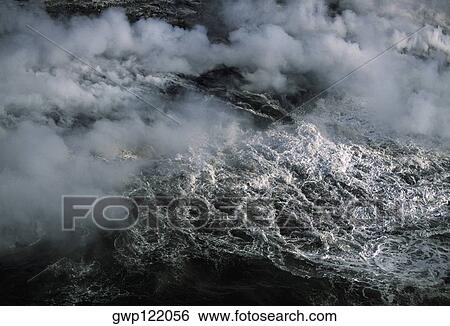 Steam rises from lava flowing into the sea, Hawaii View Large Photo Image Stock Photograph - Steam rises from lava flowing into the sea, Hawaii. Fotosearch