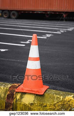 Close-up of a traffic cone with a cargo container in the background View Large Photo Image Stock Photograph - Close-up of a traffic cone with a cargo container in the background. Fotosearch