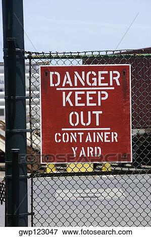 Close-up of a warning sign on a chain-link fence View Large Photo Image Stock Photo - Close-up of a warning sign on a chain-link fence. Fotosearch