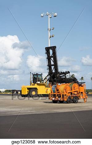 Crane and a forklift at a commercial dock View Large Photo Image Stock Photo - Crane and a forklift at a commercial dock. Fotosearch