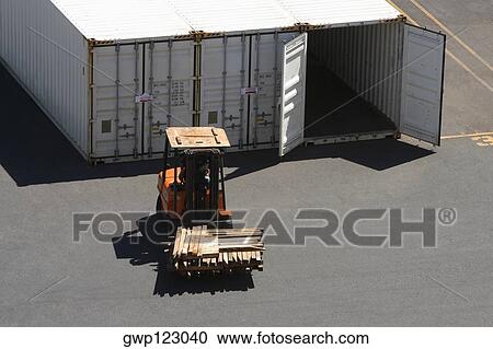 High angle view of a forklift in front of cargo containers at a commercial dock View Large Photo Image Stock Image - High angle view of a forklift in front of cargo containers at a commercial dock. Fotosearch