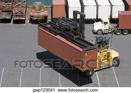 High angle view of a forklift picking up a container at a harbor View Large Photo Image Stock Image - High angle view of a forklift picking up a container at a harbor. Fotosearch