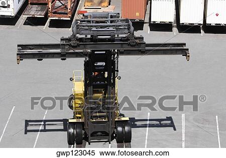 High angle view of a forklift with cargo containers in the background View Large Photo Image Stock Photography - High angle view of a forklift with cargo containers in the background. Fotosearch