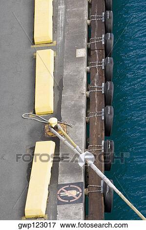 Stock Photo - High angle view of a rope tied up with a bollard. Fotosearch