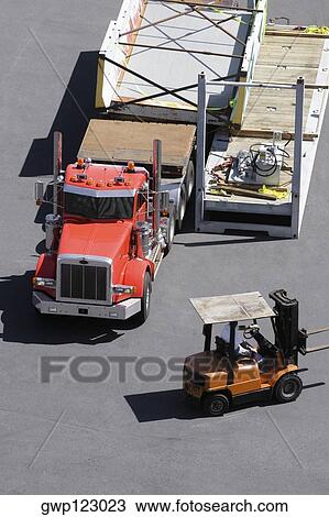 High angle view of a semi-truck and a forklift at a commercial dock View Large Photo Image Stock Image - High angle view of a semi-truck and a forklift at a commercial dock. Fotosearch