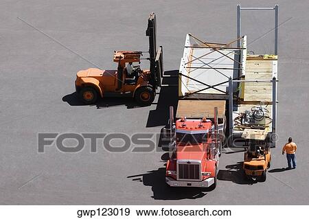 High angle view of a semi-truck and forklifts at a commercial dock View Large Photo Image Stock Photo - High angle view of a semi-truck and forklifts at a commercial dock. Fotosearch