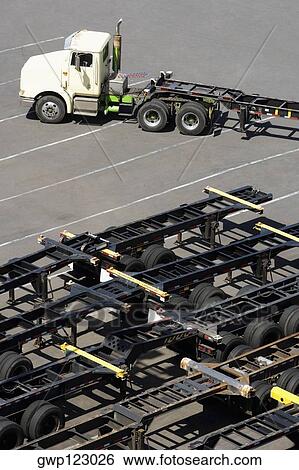 High angle view of a semi-truck with vehicle trailers at a commercial dock View Large Photo Image Stock Photograph - High angle view of a semi-truck with vehicle trailers at a commercial dock. Fotosearch
