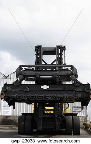 Low angle view of a forklift at a commercial dock View Large Photo Image Stock Photo - Low angle view of a forklift at a commercial dock. Fotosearch