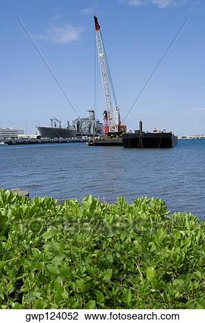Crane and a military ship in the sea, Pearl Harbor, Honolulu, Oahu, Hawaii Islands, USA View Large Photo Image Stock Image - Crane and a military ship in the sea, Pearl Harbor, Honolulu, Oahu, Hawaii Islands, USA. Fotosearch