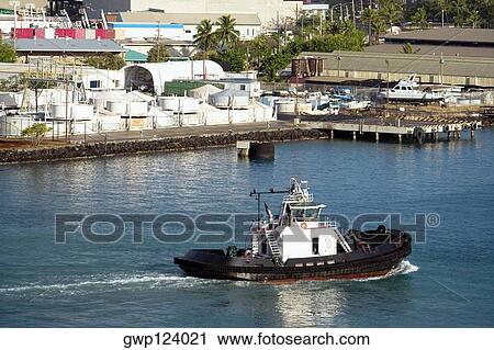 Stock Image - High angle view of a tugboat at a harbor, Honolulu Harbor, Honolulu, Oahu, Hawaii Islands, USA. Fotosearch
