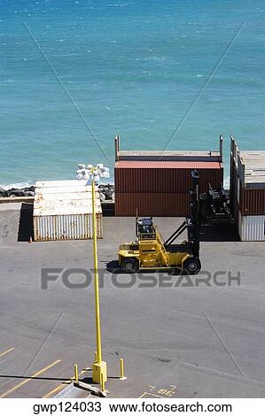 High angle view of cargo containers and a forklift at a commercial dock View Large Photo Image Stock Image - High angle view of cargo containers and a forklift at a commercial dock. Fotosearch