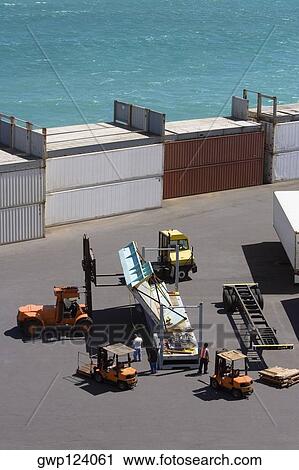 High angle view of cargo containers and forklifts at a commercial dock View Large Photo Image Stock Image - High angle view of cargo containers and forklifts at a commercial dock. Fotosearch