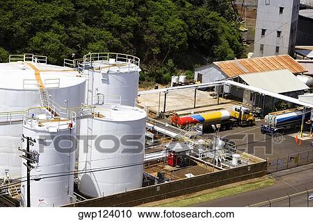 Stock Image - High angle view of storage tanks at an oil refinery, Nawiliwili Beach Park, Kauai, Hawaii Islands, USA. Fotosearch
