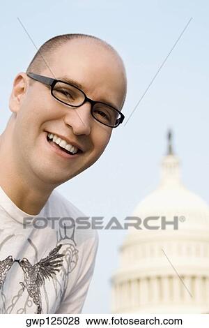 Close-up of a mid adult man smiling in front of a building, Capitol Building, Washington DC, USA View Large Photo Image Stock Photo - Close-up of a mid adult man smiling in front of a building, Capitol Building, Washington DC, USA. Fotosearch