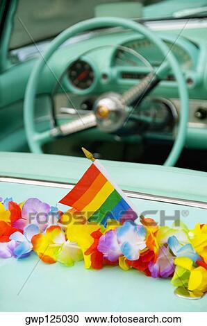 Close-up of flowers and a flag on a car View Large Photo Image Stock Image - Close-up of flowers and a flag on a car. Fotosearch