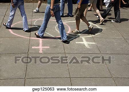 Group of people walking on two female symbols drawn with a heart shape on the road View Large Photo Image Stock Image - Group of people walking on two female symbols drawn with a heart shape on the road. Fotosearch