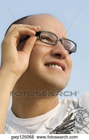 Low angle view of a mid adult man smiling View Large Photo Image Stock Photo - Low angle view of a mid adult man smiling. Fotosearch