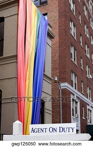 Low angle view of a rainbow flag hanging on a building View Large Photo Image Stock Image - Low angle view of a rainbow flag hanging on a building. Fotosearch