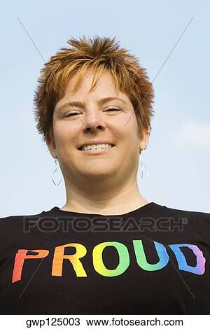 Low angle view of a young woman smiling View Large Photo Image Stock Image - Low angle view of a young woman smiling. Fotosearch