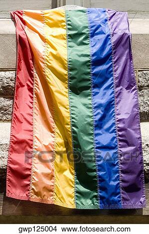 Rainbow flag hanging on a window of a building View Large Photo Image Picture - Rainbow flag hanging on a window of a building. Fotosearch