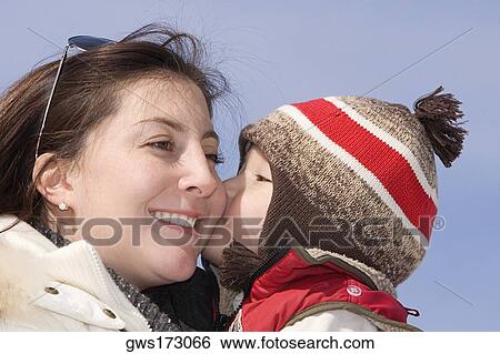Close-up of a boy kissing his mother View Large Photo Image Stock Photograph - Close-up of a boy kissing his mother. Fotosearch