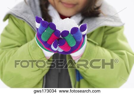 Close-up of a girl holding a snowball View Large Photo Image Picture - Close-up of a girl holding a snowball. Fotosearch