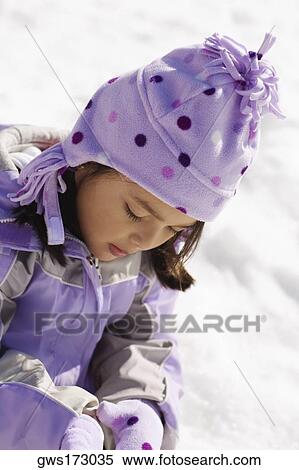 Close-up of a girl sitting on snow View Large Photo Image Stock Photography - Close-up of a girl sitting on snow. Fotosearch