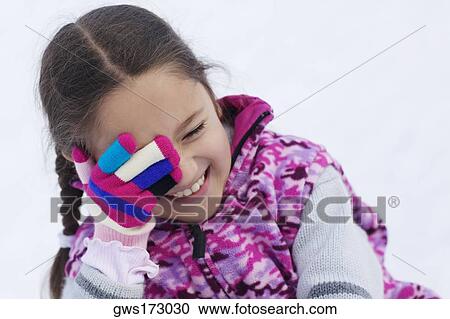 Close-up of a girl smiling with her hand covering her eye View Large Photo Image Stock Image - Close-up of a girl smiling with her hand covering her eye. Fotosearch