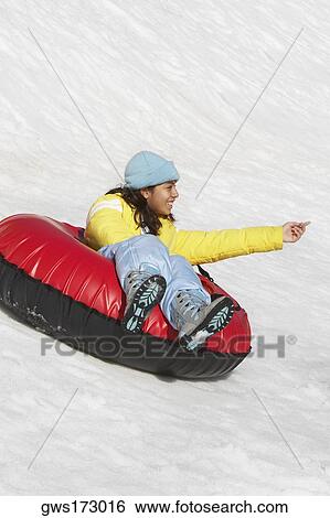Stock Photograph - Girl sliding in an inflatable ring. Fotosearch