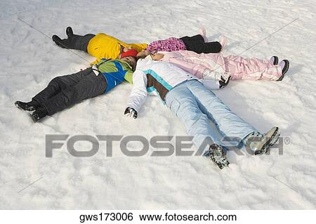 High angle view of five children lying on snow View Large Photo Image Stock Photograph - High angle view of five children lying on snow. Fotosearch