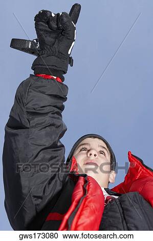 Low angle view of a boy pointing View Large Photo Image Stock Image - Low angle view of a boy pointing. Fotosearch