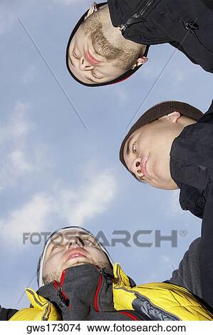 Low angle view of three young men View Large Photo Image Picture - Low angle view of three young men. Fotosearch