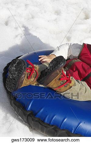 Low section view of a person sitting in an inner tube View Large Photo Image Stock Photo - Low section view of a person sitting in an inner tube. Fotosearch
