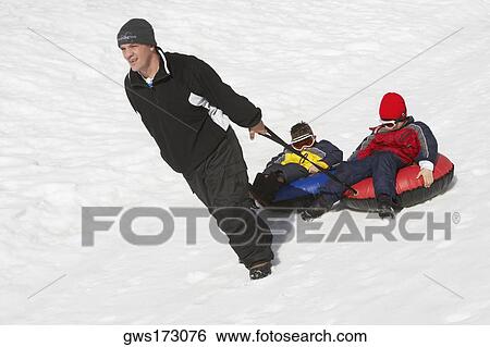 Mature man pulling his two children sitting on inner tubes View Large Photo Image Stock Photograph - Mature man pulling his two children sitting on inner tubes. Fotosearch