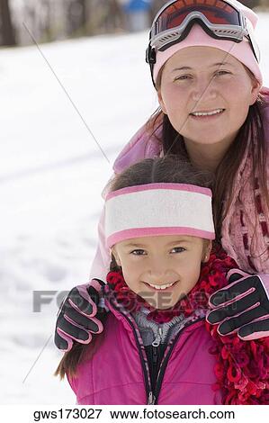 Mid adult woman standing with her daughter View Large Photo Image Stock Photo - Mid adult woman standing with her daughter. Fotosearch