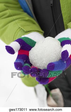 Mid section view of a person holding a snowball View Large Photo Image Stock Image - Mid section view of a person holding a snowball. Fotosearch