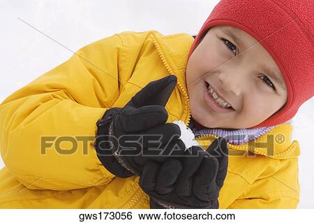 Portrait of a boy holding a snowball View Large Photo Image Stock Photograph - Portrait of a boy holding a snowball. Fotosearch
