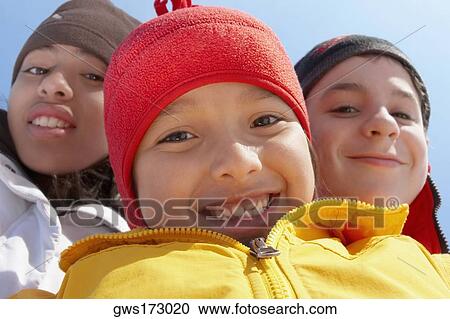 Portrait of a boy smiling with his two friends View Large Photo Image Stock Image - Portrait of a boy smiling with his two friends. Fotosearch