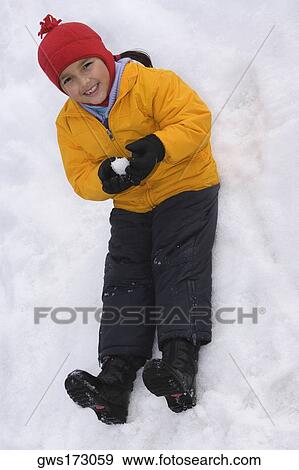 Portrait of a girl holding a snowball View Large Photo Image Stock Photo - Portrait of a girl holding a snowball. Fotosearch