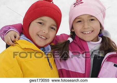 Portrait of a girl smiling with her brother View Large Photo Image Stock Photography - Portrait of a girl smiling with her brother. Fotosearch