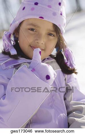 Portrait of a girl with her finger on her lips View Large Photo Image Stock Photograph - Portrait of a girl with her finger on her lips. Fotosearch